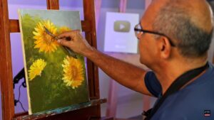 Pincéis e tintas a óleo: Artista pintando girassóis